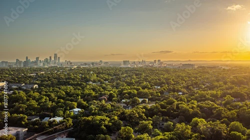 4K+ Aerial time-lapse over Mueller of Austin, Texas with a view of the downtown skyscrapers at sunset
