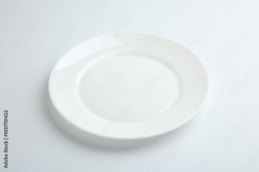 One empty ceramic plate isolated on white One empty ceramic plate isolated on white