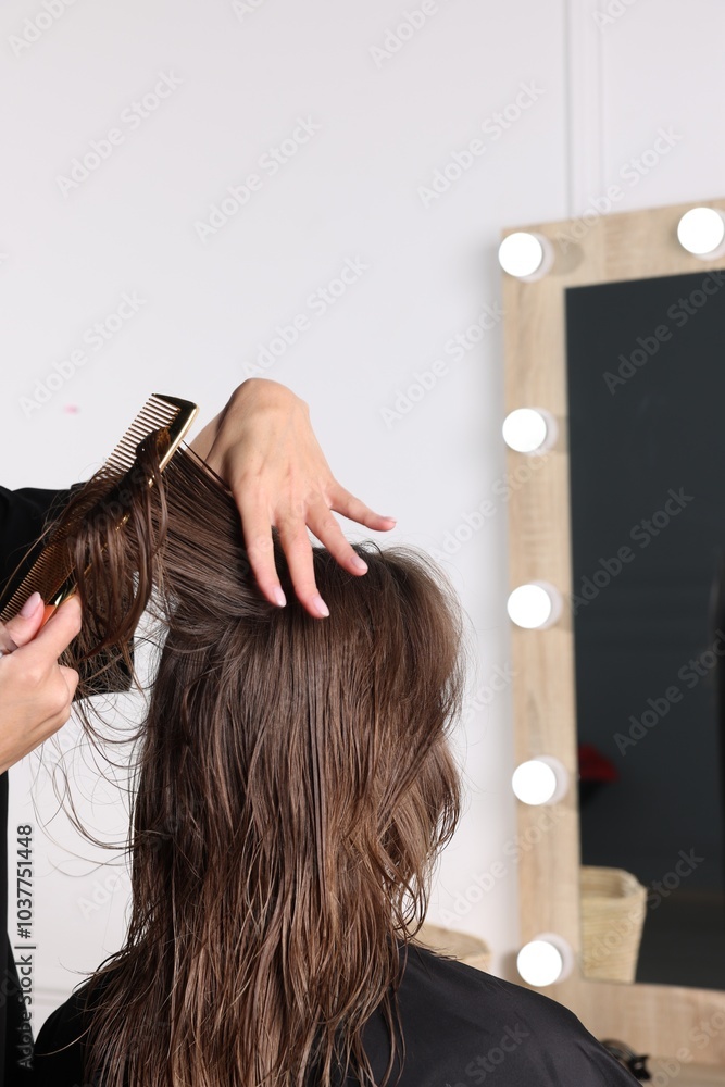 Fototapeta premium Hair cutting. Professional hairdresser working with client in salon, closeup