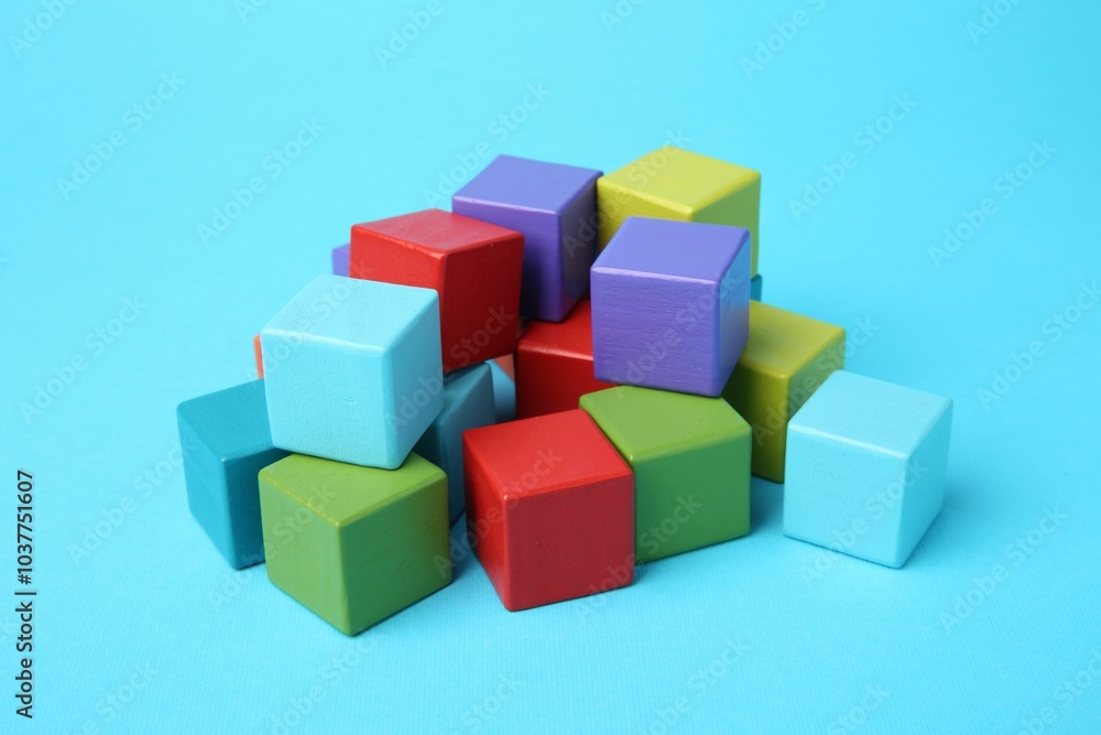 Many colorful cubes on light blue background Many colorful cubes on light blue background