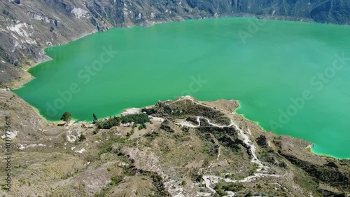 Aerial view of the world's largest volcanic crater, the Quilotoa supervolcano, covered with greenish water forming the Quilotoa Lagoon, Ecuadorian Andes.