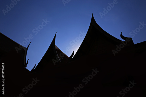 Silhouette thai gable roof commonly used with temples or traditional Thai houses  photo