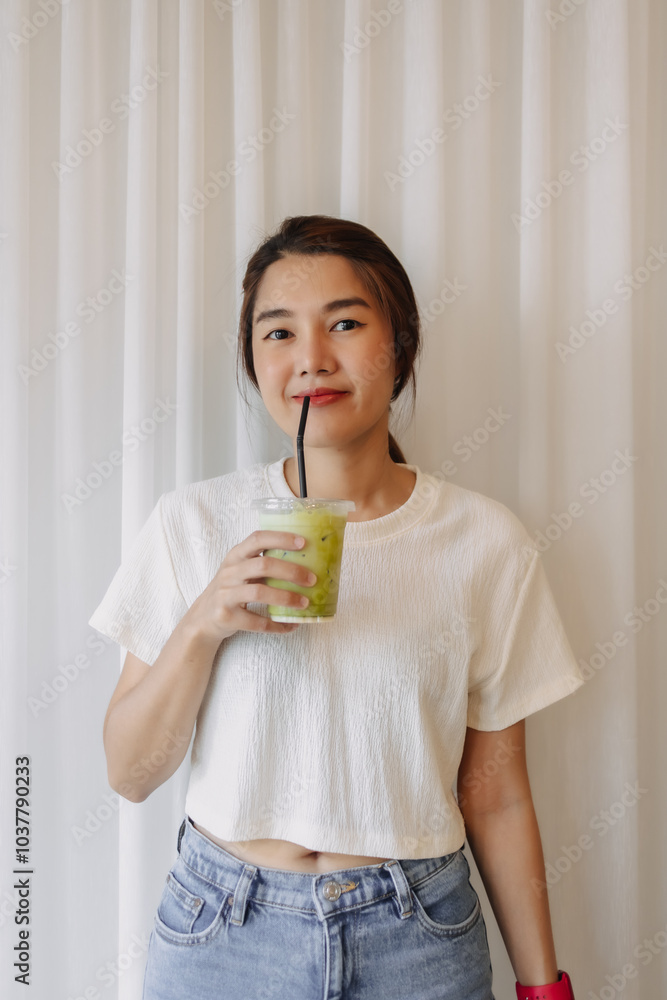 Happy healthy Asian woman drinking Iced Latte Matcha Green Tea. Happy healthy Asian woman drinking Iced Latte Matcha Green Tea.