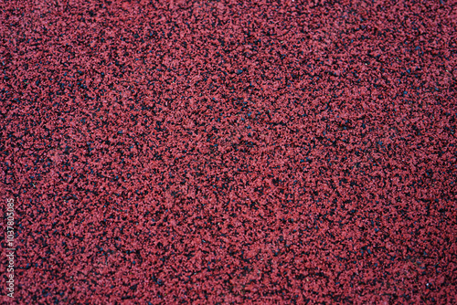 Close-up of a red textured abstract background with various fragments scattered across the surface