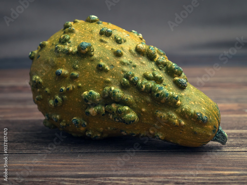 Cucurbita fruit on wooden desk. Close-up