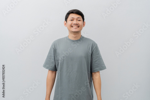 Happy expression of adult Asian man with casual t-shirt isolated on white background photo