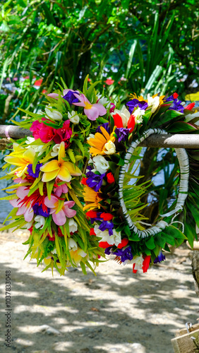 Polynesian cultural lei of beautiful colourful flowers at market stall on the tropical island of Mo'orea in French Polynesia, South Pacific