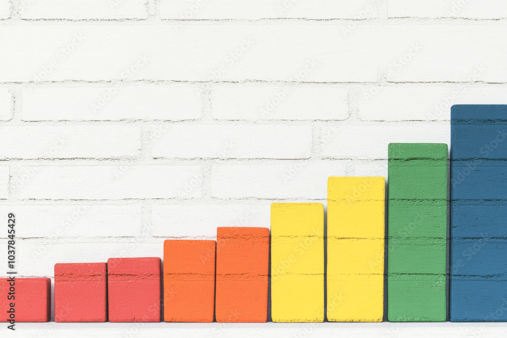 A wall with a series of colorful blocks stacked on top of each other A wall with a series of colorful blocks stacked on top of each other