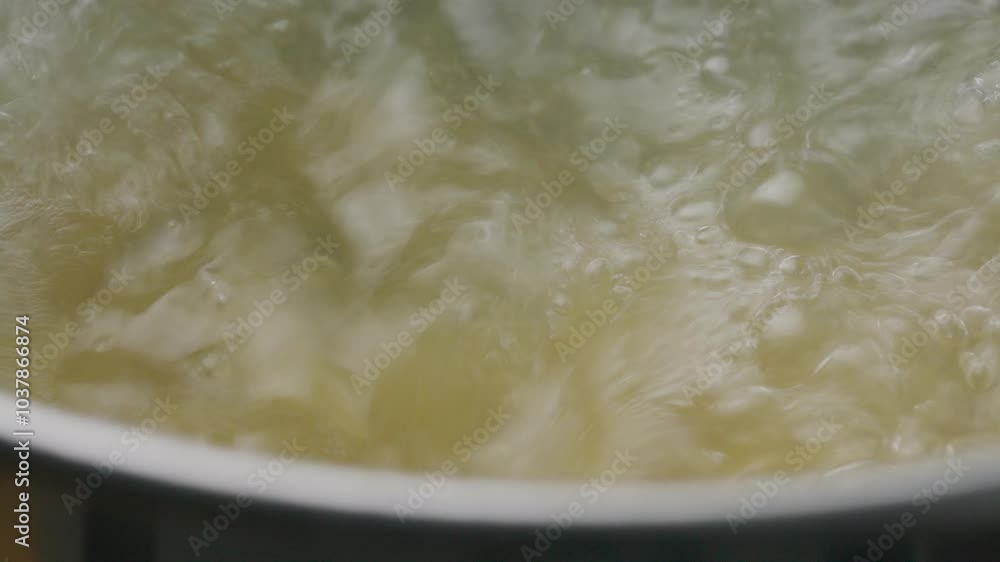 Extreme close-up view of stirring penne in boiling water while cooking in pot Extreme close-up view of stirring penne in boiling water while cooking in pot