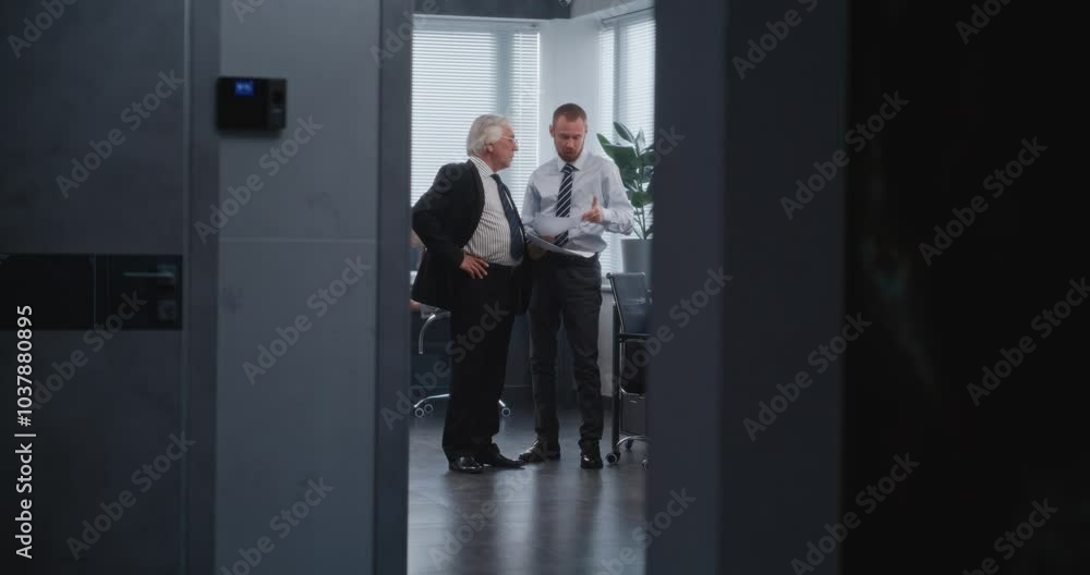 Team leader of department's managers discussing business strategy of company with boss, analyzing papers and documents. Female manager enters meeting room. Business and entrepreneurship concept. Team leader of department's managers discussing business strategy of company with boss, analyzing papers and documents. Female manager enters meeting room. Business and entrepreneurship concept.