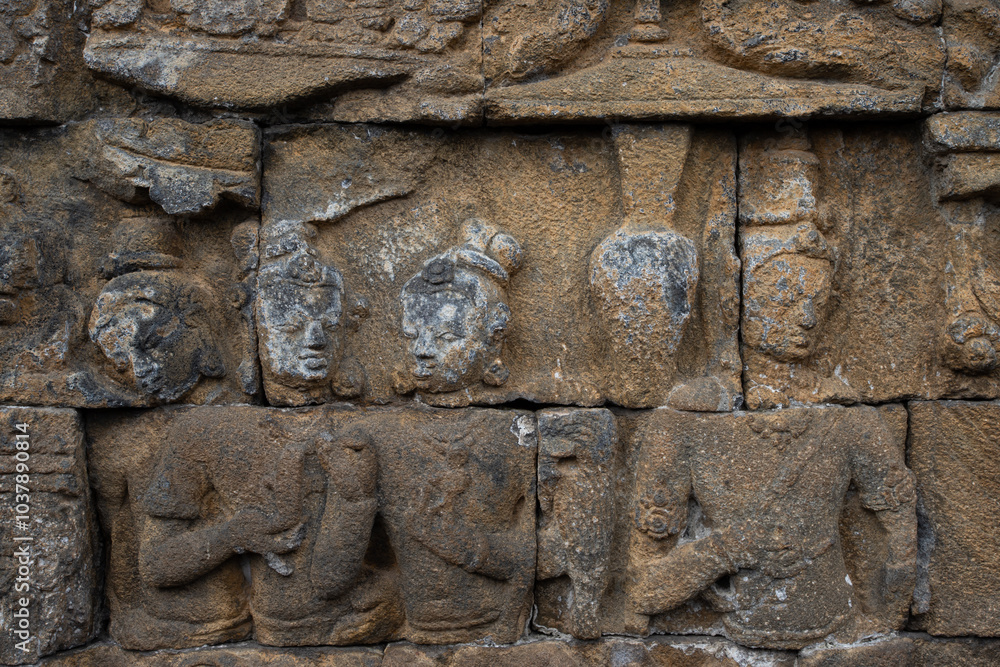 Wall with old stone statues in Borobudur Temple in Indonesia Wall with old stone statues in Borobudur Temple in Indonesia