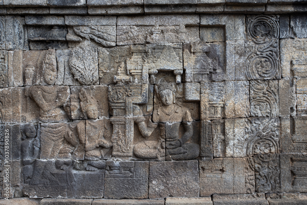 Wall with old religious stone statues in Borobudur Temple in Indonesia Wall with old religious stone statues in Borobudur Temple in Indonesia