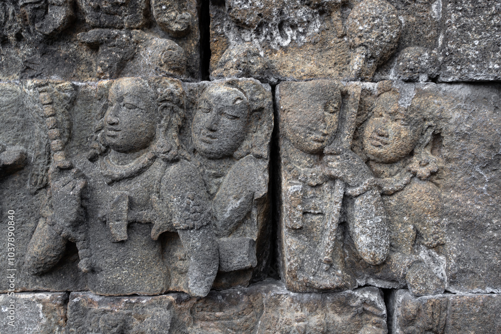 Wall with old historic stone statues in Borobudur Temple in Indonesia Wall with old historic stone statues in Borobudur Temple in Indonesia