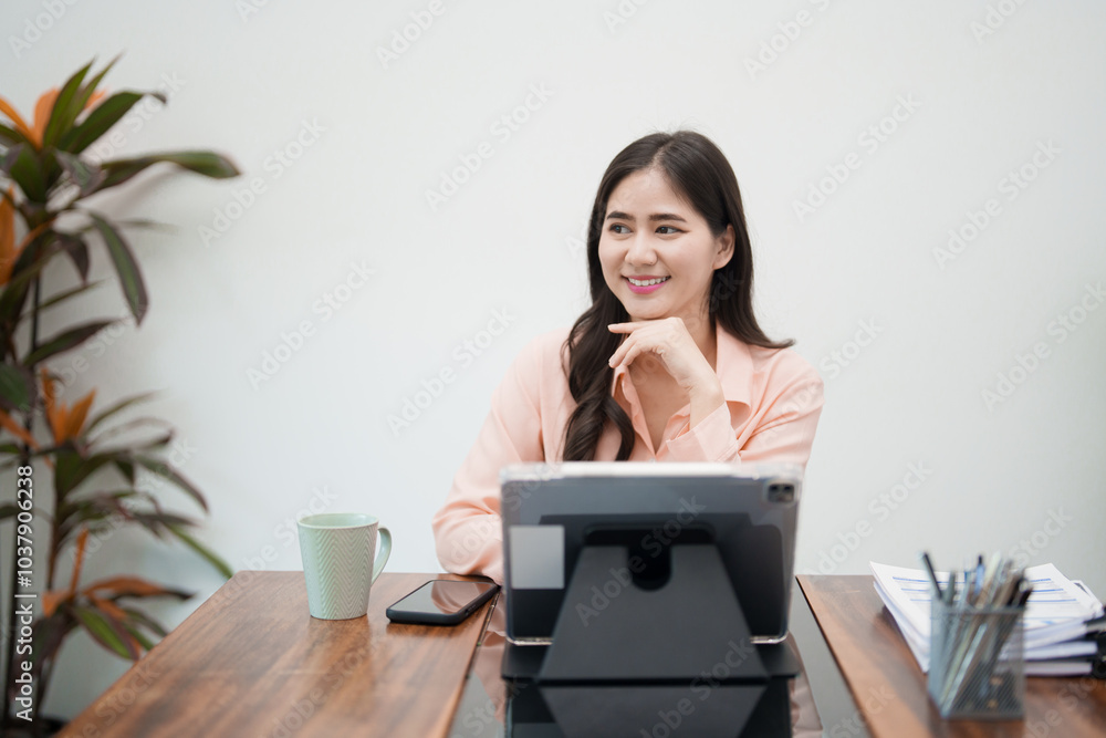 A young woman is sitting at her desk, gazing thoughtfully out the window. She appears deep in thought, with a calm and reflective expression A young woman is sitting at her desk, gazing thoughtfully out the window. She appears deep in thought, with a calm and reflective expression