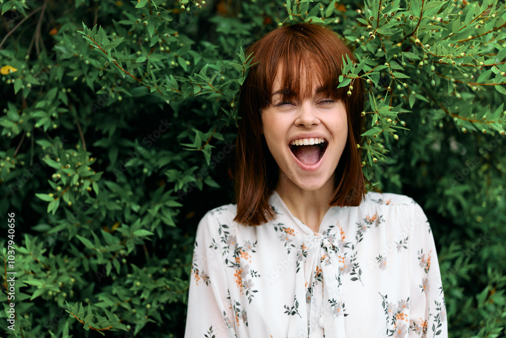 Joyful woman laughing in nature surrounded by lush greenery and trees Joyful woman laughing in nature surrounded by lush greenery and trees