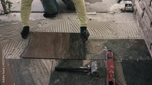 Phoenix, Arizona, AZ, USA.9.23.24. An unidentified tiler is installing ceramic tiles in a house.