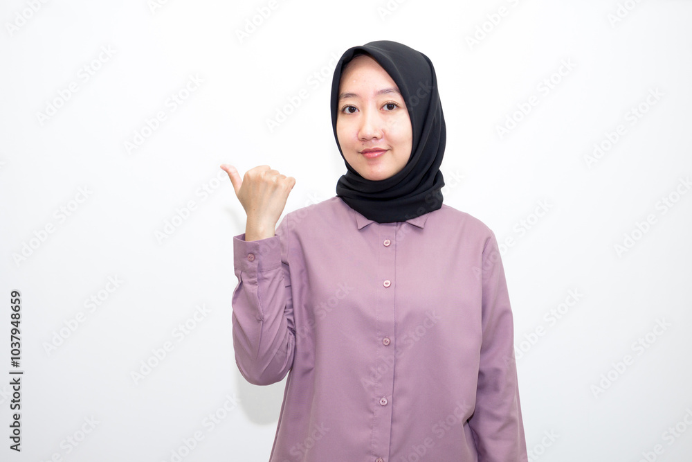 portrait of Indonesian Asian woman wearing shirt and hijab pointing with one and two hands to right, left and front. pointing to empty direction for advertising space.. Isolated on white background portrait of Indonesian Asian woman wearing shirt and hijab pointing with one and two hands to right, left and front. pointing to empty direction for advertising space.. Isolated on white background