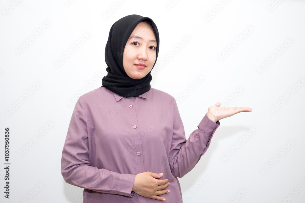 portrait of Indonesian Asian woman wearing shirt and hijab pointing with one and two hands to right, left and front. pointing to empty direction for advertising space.. Isolated on white background portrait of Indonesian Asian woman wearing shirt and hijab pointing with one and two hands to right, left and front. pointing to empty direction for advertising space.. Isolated on white background