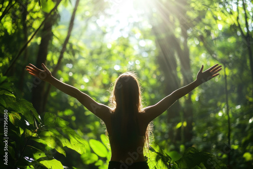 Woman joyfully with arms outstretched. Sun setting behind her, casting a golden glow on the beach. Waves gently crashing in the background. photo