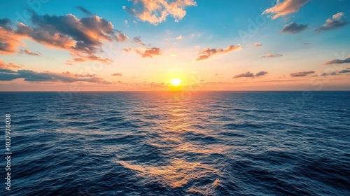 A serene sunset over the ocean, casting vibrant colors across the water.