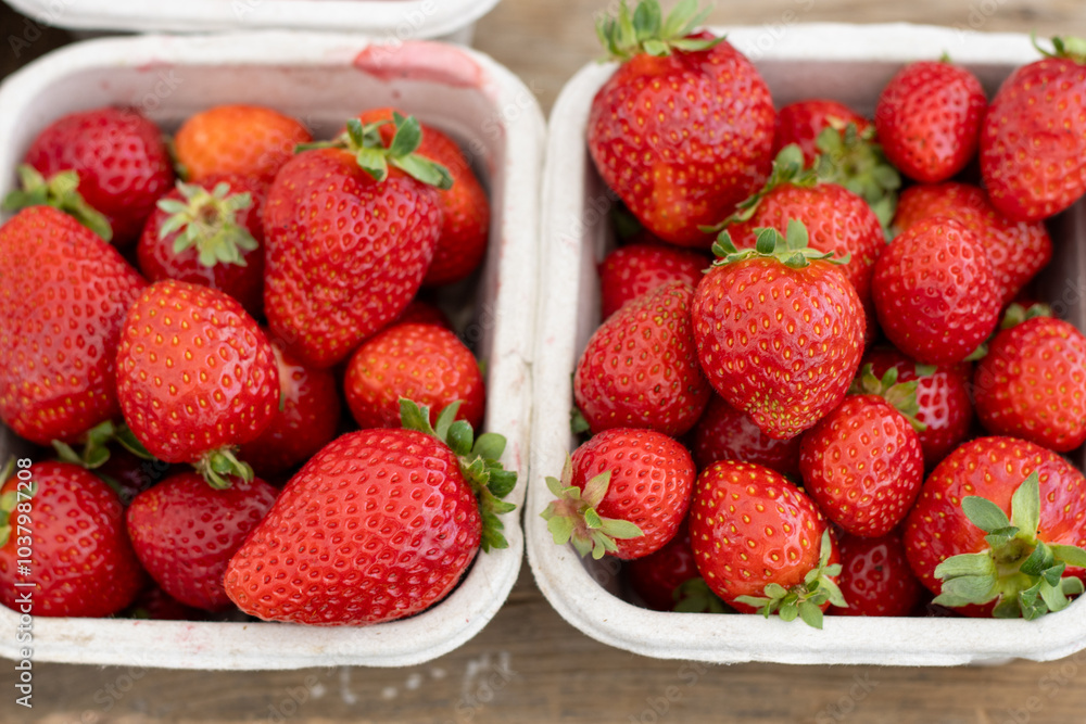 Fresh strawberries in cartons on display at a farmers market Fresh strawberries in cartons on display at a farmers market