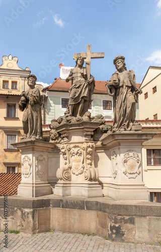 Sculpture of St Cosmas, Damian and Savior by Jan Oldrich Mayer on the Charles Bridge in Prague in Czech Republic photo