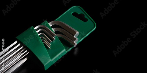 Hex key allen wrench set for repair and construction work on black background. photo