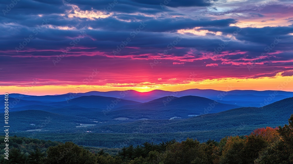Fototapeta premium Vibrant Sunset Over Rolling Mountain Landscape