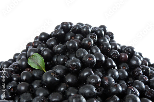 A heap of fresh aronia berries decorated with a green leaf, white background