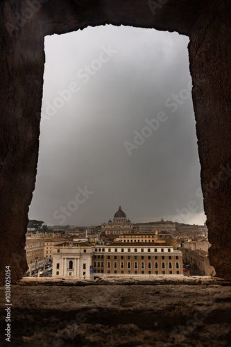 A view of a city from a window with a cloudy sky