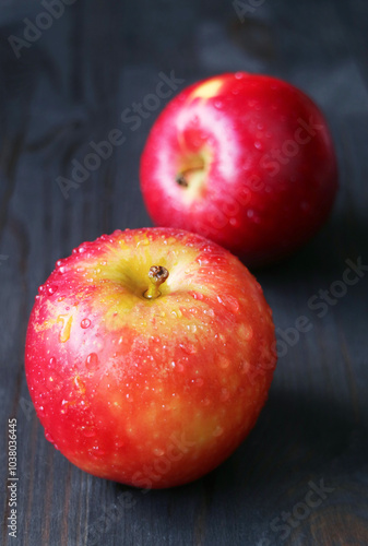 Pair of fresh ripe red apple isolated on black wooden background photo