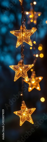 Warm glowing star lights hanging outdoors under a twilight sky surrounded by ...