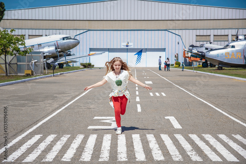 Girl Running Down Runway at Aviation Museum
