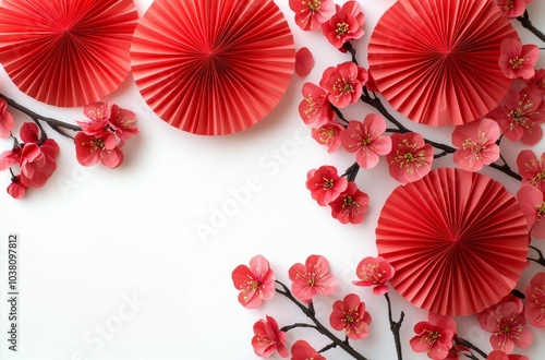 Delicate red fans and cherry blossoms arranged artistically on a light backgr...