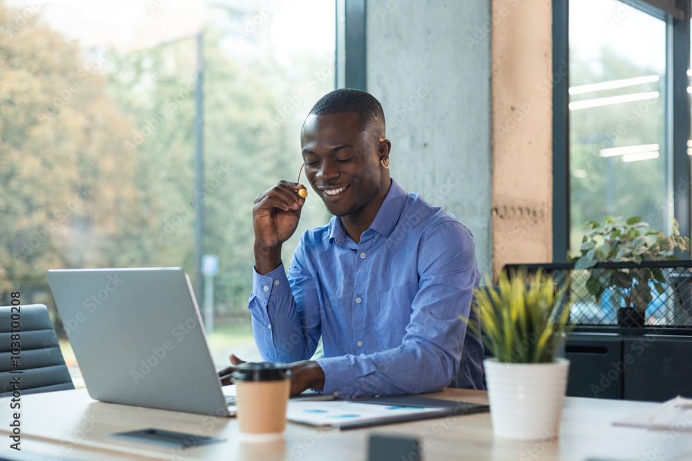 Fototapeta premium Happy young african male customer support executive working in office.