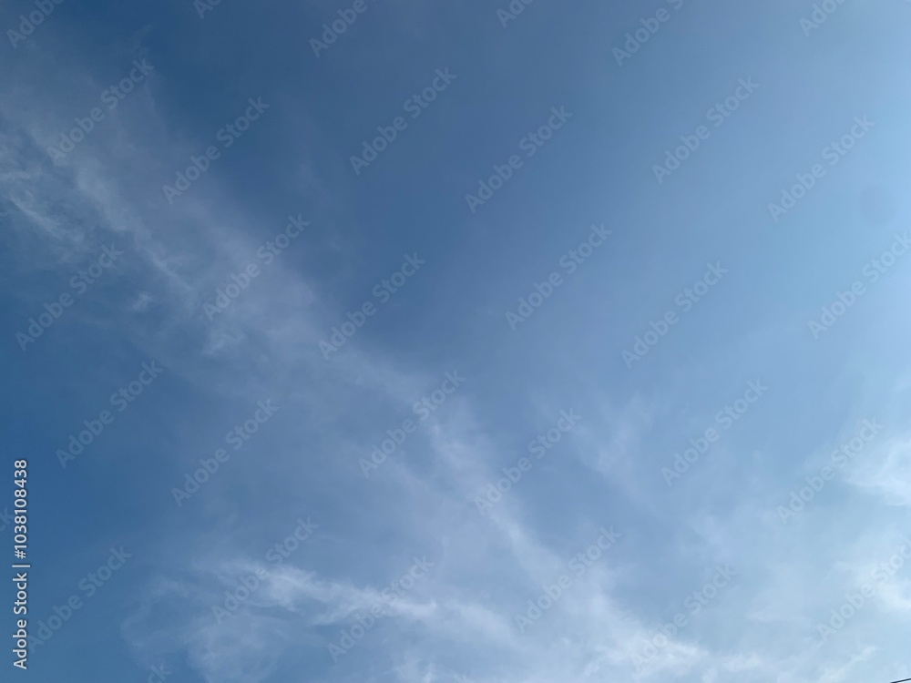 Fototapeta premium Image of blue sky with a few strip clouds