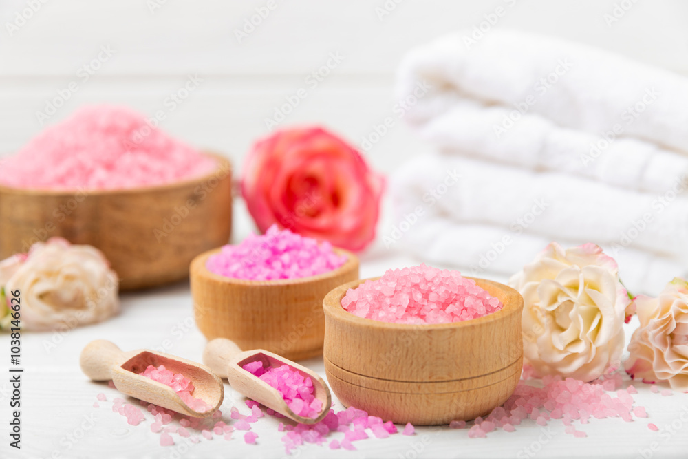 Sea salt for bath with aroma and rose flowers on textured wooden background. Pink sea salt. Spa treatments. Natural salt with herbs and essential oils. skincare concept. Meso for text. Copy space Sea salt for bath with aroma and rose flowers on textured wooden background. Pink sea salt. Spa treatments. Natural salt with herbs and essential oils. skincare concept. Meso for text. Copy space