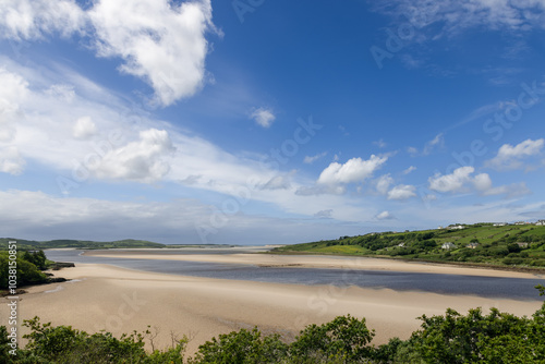 Wallpaper Mural At low tide, the Gweebarra River flows into the Atlantic Ocean, revealing endless sandy shores under a vast blue sky Torontodigital.ca