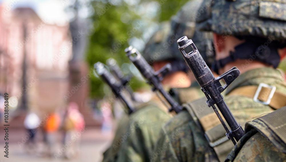Brave soldier in camouflage uniform standing at attention with rifle on shoulder Brave soldier in camouflage uniform standing at attention with rifle on shoulder