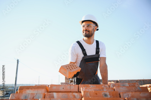 Construction worker in uniform and safety equipment have job on building photo