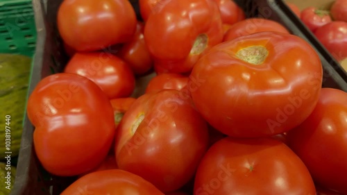 ripe red tomato neatly stacked in wooden box. Tomato with bright color and freshness. Store offers wide selection of such juicy tomato. Buyers can choose largest and ripest vegetables. photo