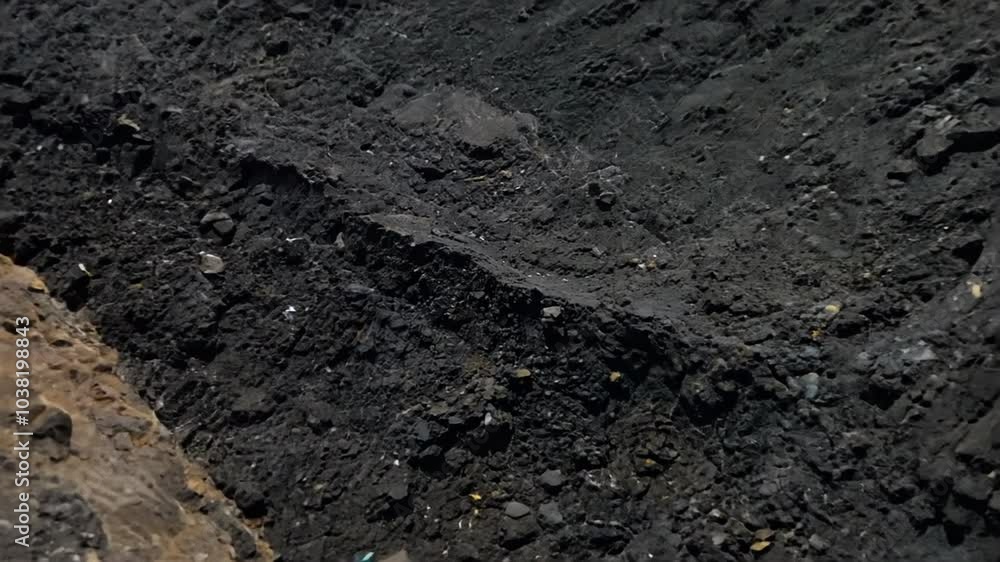 Geological section of soil, layers of coal and rock. Overburden open mine anthracite. Dark texture black color, zoom in. slow motion. 4K video Geological section of soil, layers of coal and rock. Overburden open mine anthracite. Dark texture black color, zoom in. slow motion. 4K video