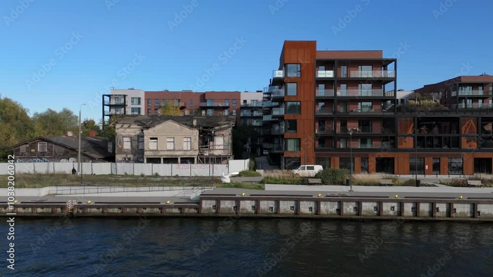 Contrast of Modern Apartments and Abandoned Building by Waterfront Contrast of Modern Apartments and Abandoned Building by Waterfront