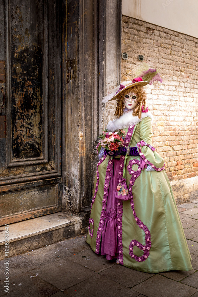 Venice, Italy - February 4, 2024: Pretty costumes worn by a woman during the Venice carnival in Italy Venice, Italy - February 4, 2024: Pretty costumes worn by a woman during the Venice carnival in Italy