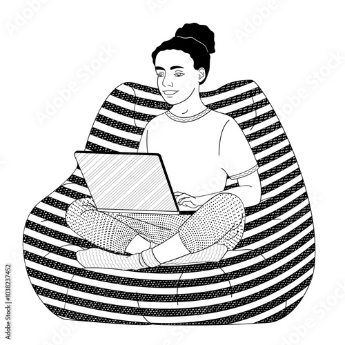 African American girl sitting in a chair with a laptop on her lap