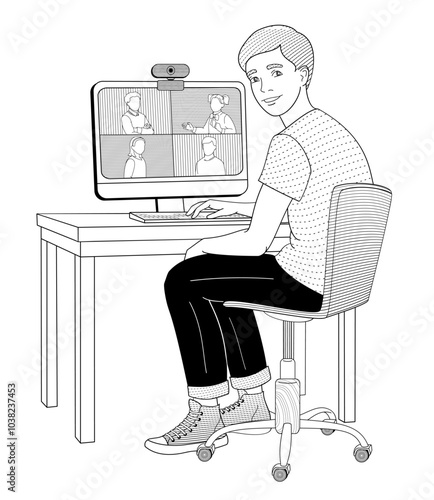 boy sits in a chair at a table working on a computer videoconferencing