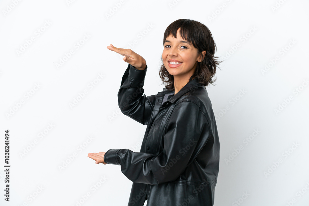 Young mixed race woman isolated on white background holding copyspace to insert an ad Young mixed race woman isolated on white background holding copyspace to insert an ad