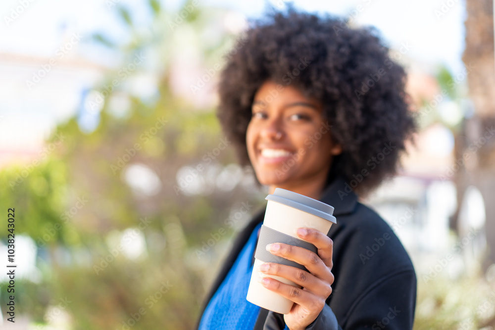 African American girl at outdoors holding a take away coffee with happy expression African American girl at outdoors holding a take away coffee with happy expression