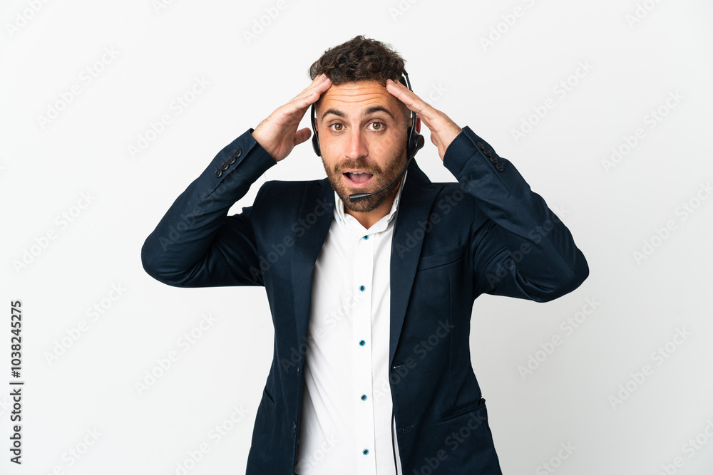 Telemarketer man working with a headset isolated on white background with surprise expression Telemarketer man working with a headset isolated on white background with surprise expression