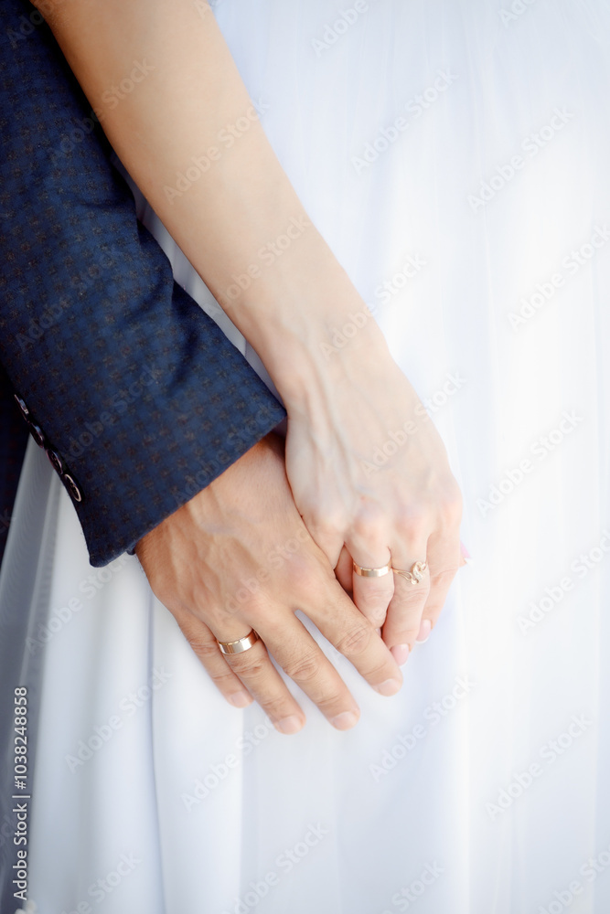 A couple in love touches each other with their hands. Love story of a young couple in love. Wedding rings on ring fingers. Concept of a marriage proposal. Starting a family. A couple in love touches each other with their hands. Love story of a young couple in love. Wedding rings on ring fingers. Concept of a marriage proposal. Starting a family.